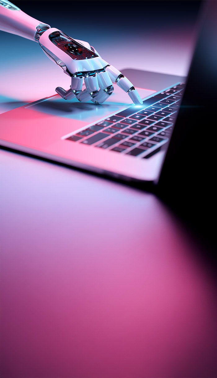 A robotic hand typing on a laptop keyboard, symbolizing Artificial Intelligence.