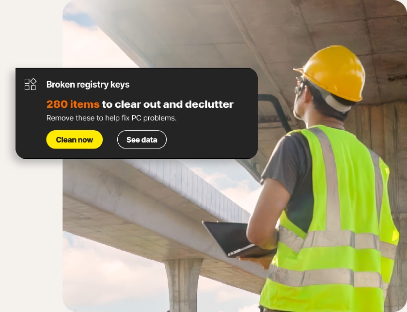 A man using Norton Utilities Ultimate to clean his PC at a construction site.