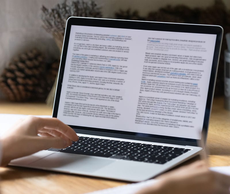 A person opening a virus-infected PDF on their laptop computer.