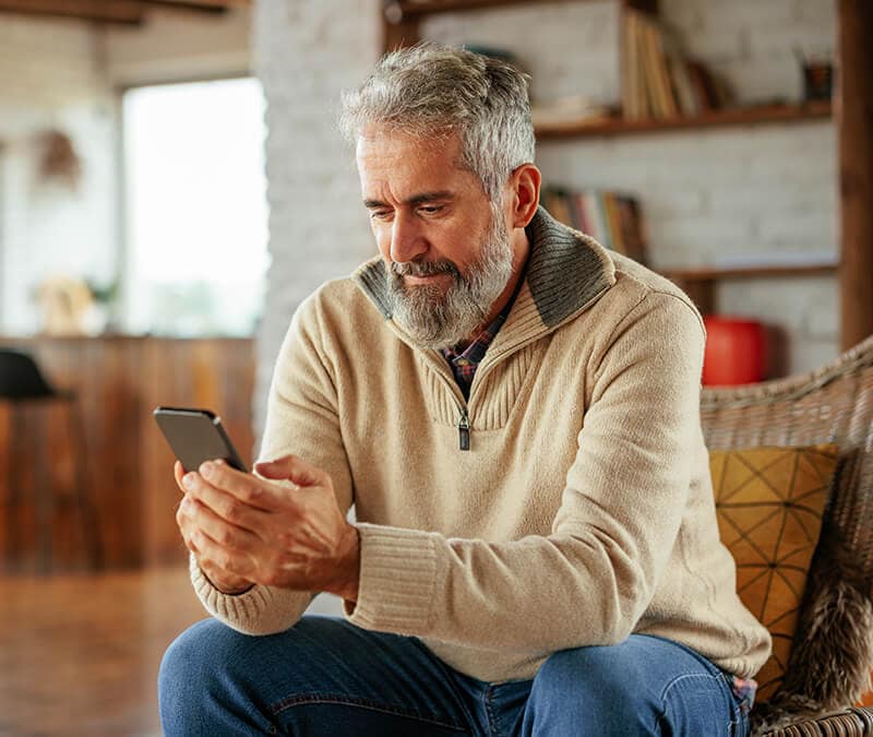 A man viewing a CCSPayment request on his mobile phone.