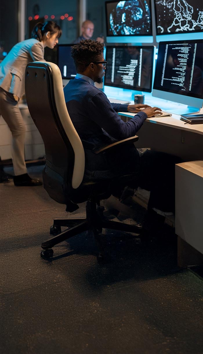 A man staring at a computer screen dealing with a data breach