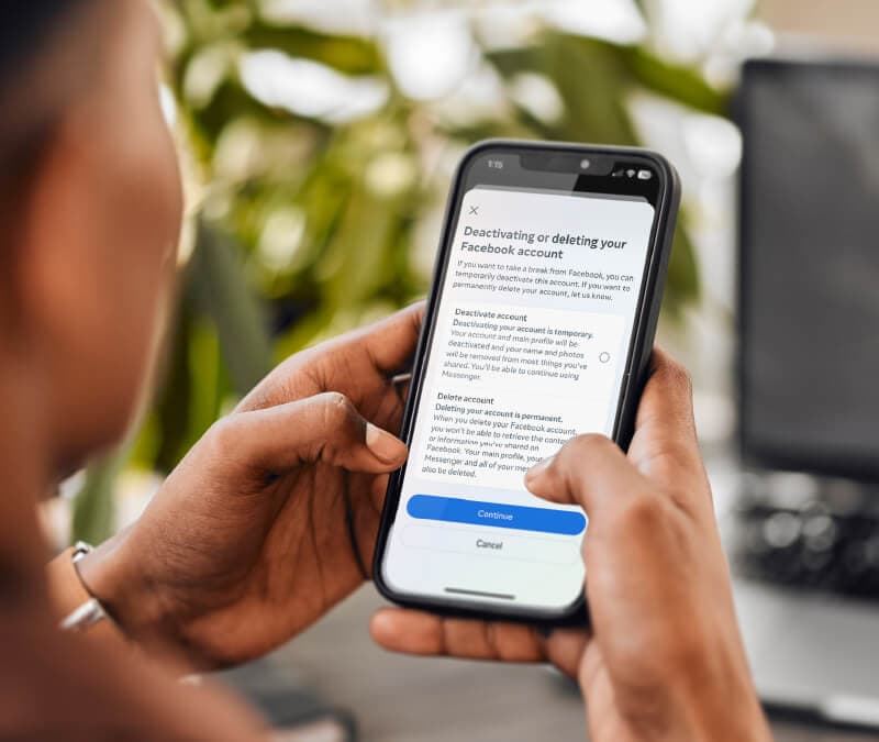 A woman deleting her Facebook account on her phone.