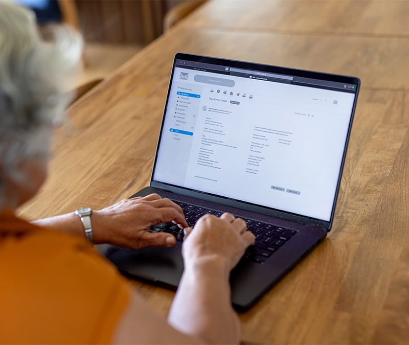 A woman assesses a Docusign email on her laptop.