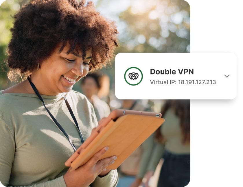 A woman with curly hair and a green shirt checks the status of her VPN on a tablet.