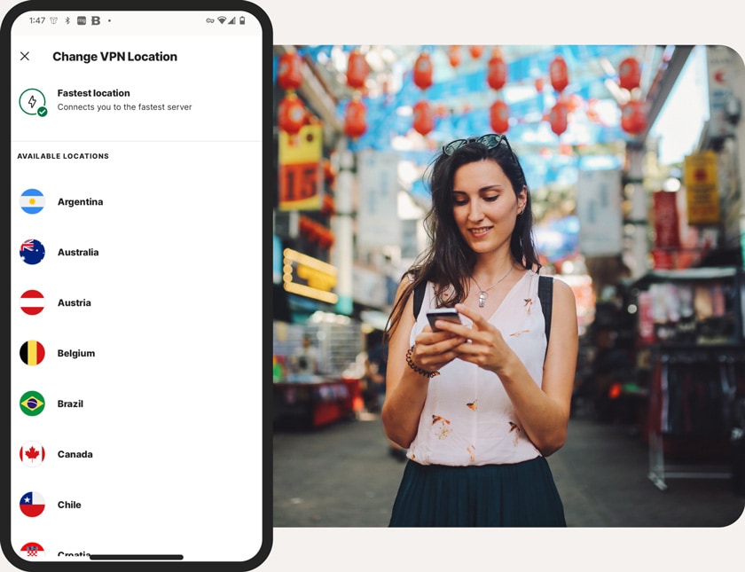 A woman standing on the street changes her VPN location.