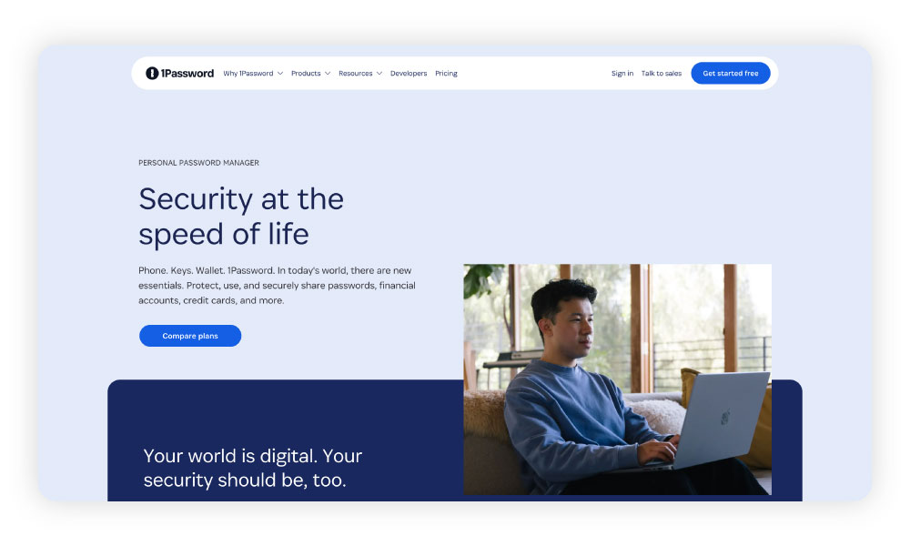 Screenshot of 1Password Families homepage featuring a man using a password manager on his laptop.