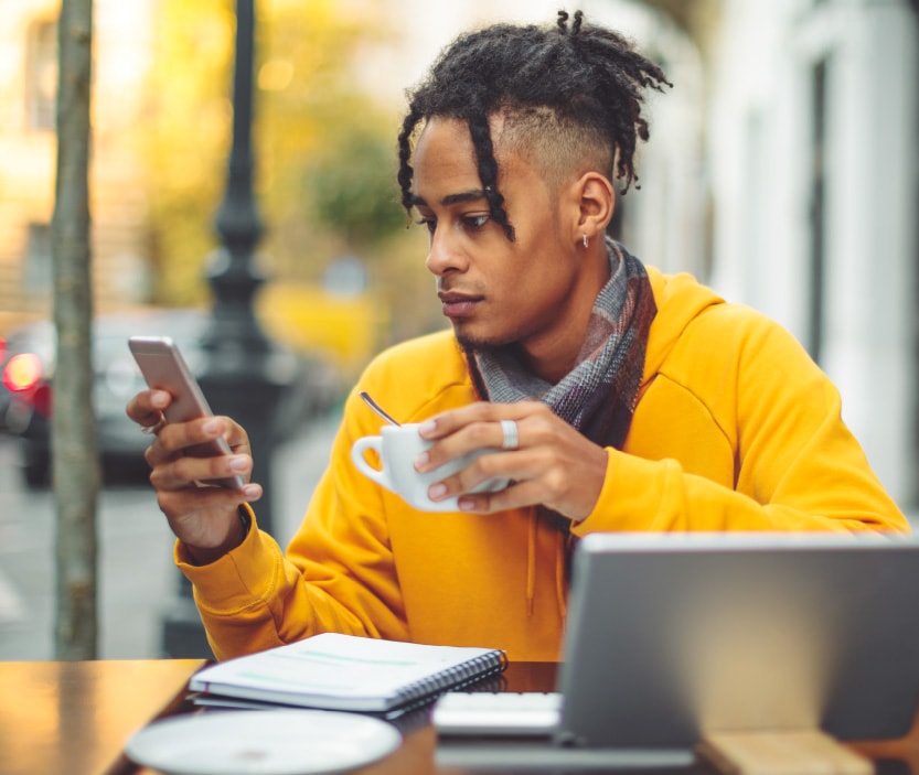 A person connects to public Wi-Fi so he can use his phone while he sits at a local coffee shop. 