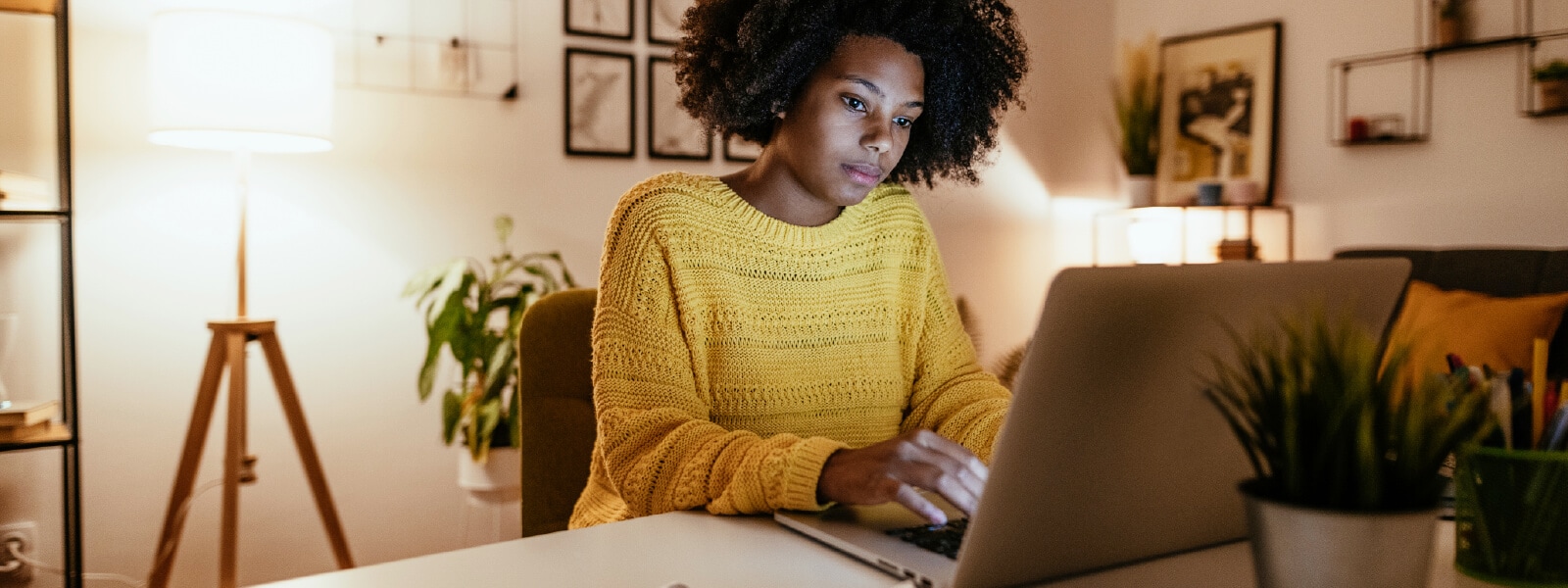 A woman looks at a message on her computer that could be a Google Chat scam.