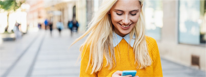 A woman unlocks her phone using facial recognition.