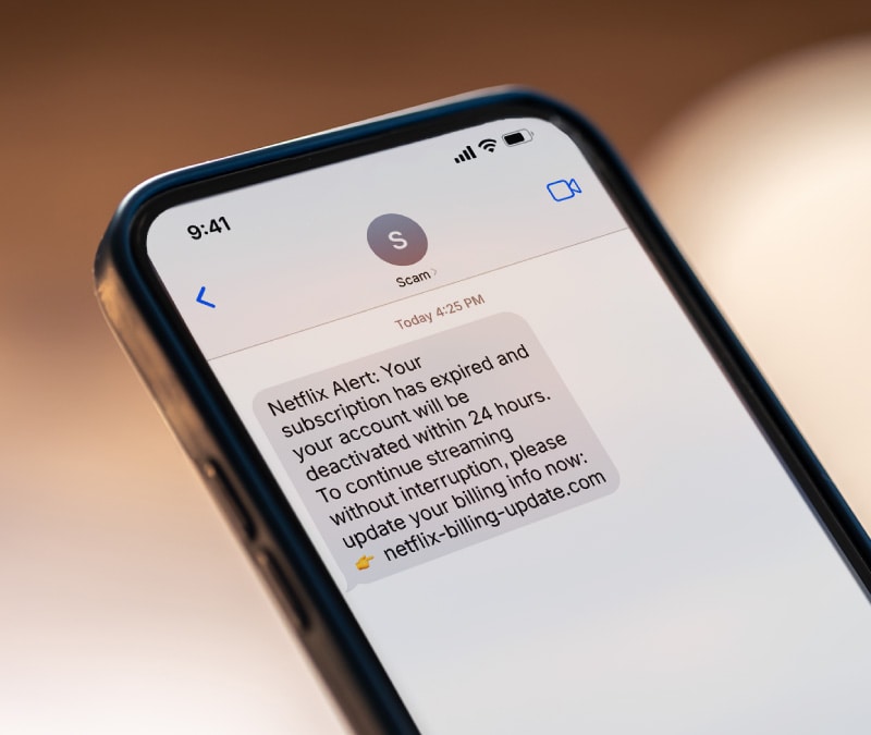 Close-up of a phone showing a potential fake text message.