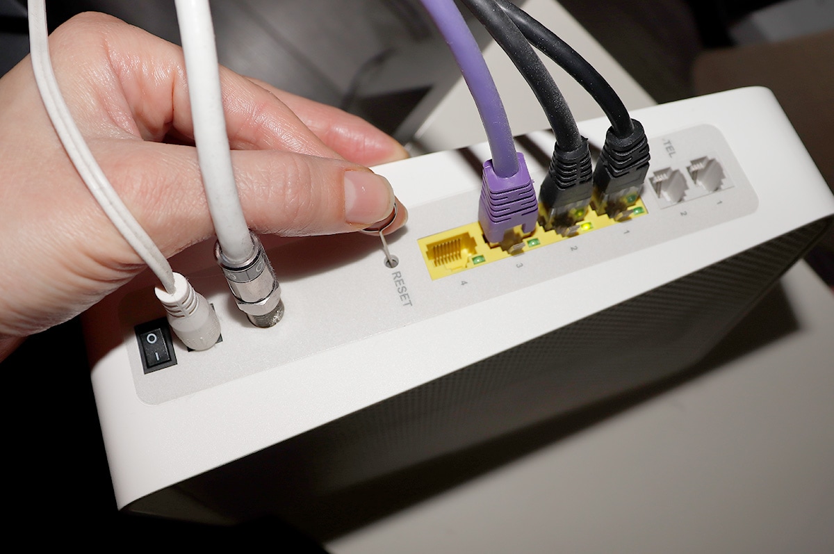 To reset your router you normally need a sharp object like a pin to press into the reset button for 15 seconds.