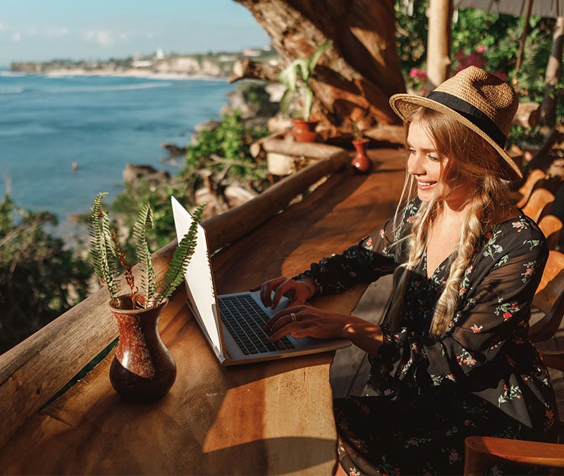 A woman happily browsing knowing that her online data is protected by a verified no-log VPN.