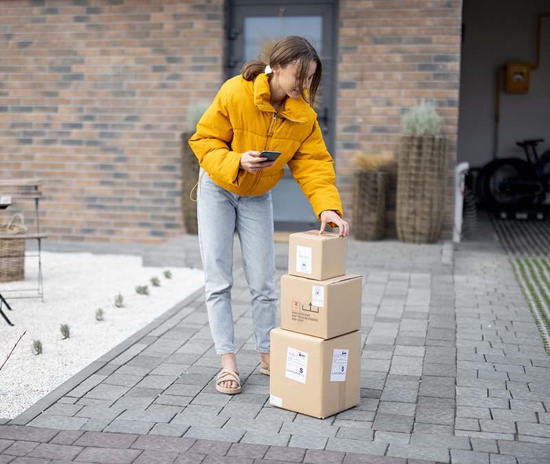 Person with yellow jacket tracking her packages.