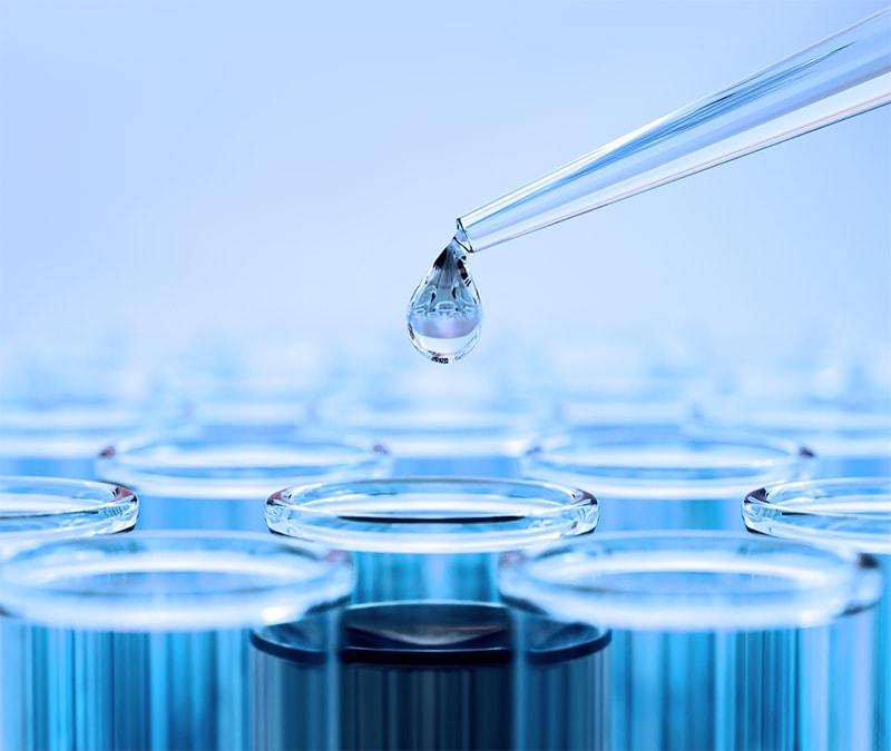 Image of a pipette dripping water over a tube, representing a prompt injection attack.