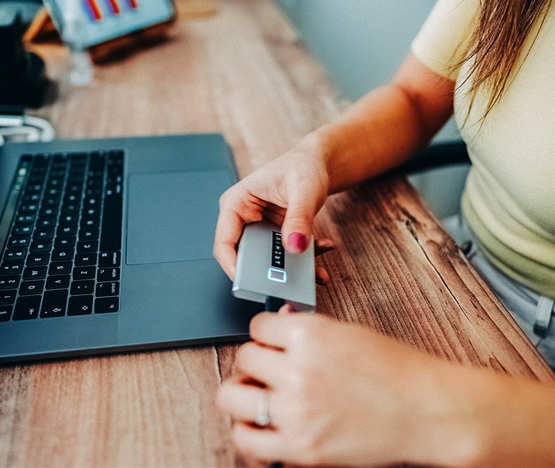 An image of someone using an external hard drive to protect their files in case of ransomware