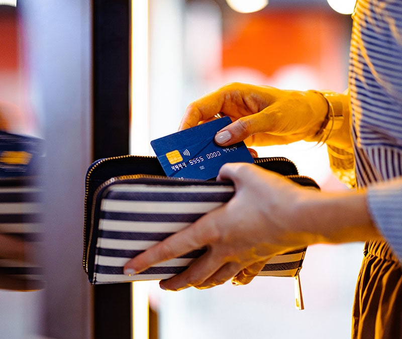 Image of someone pulling out a card from what could possibly be an RFID-blocking bag.