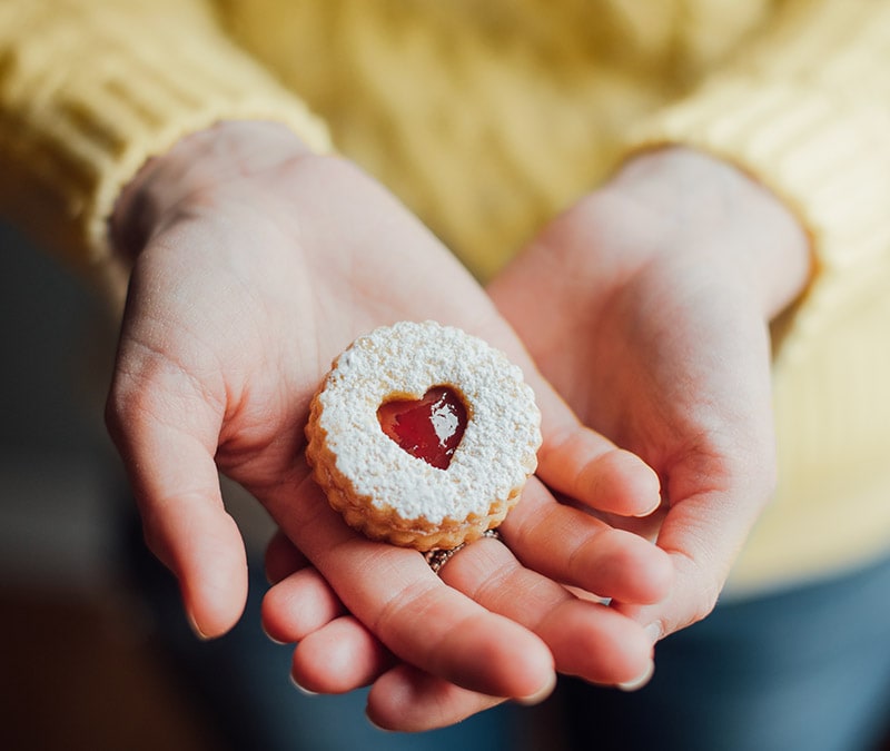 Hands cupped together holding a cookie