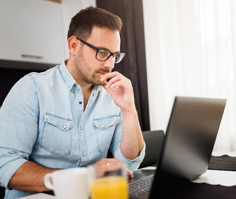 A man reads about a smurf attack on his laptop.