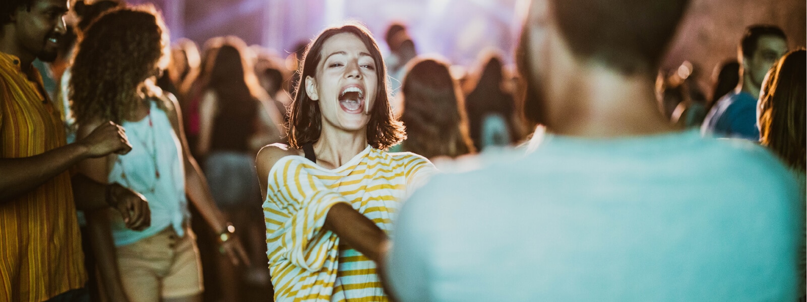 People at a Ticketmaster event having fun in a crowd, most likely a concert.