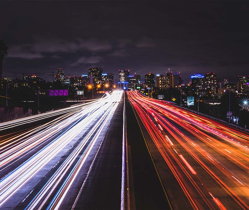 The lights from traffic speeding down a highway in two different directions, representing UDP vs TCP.