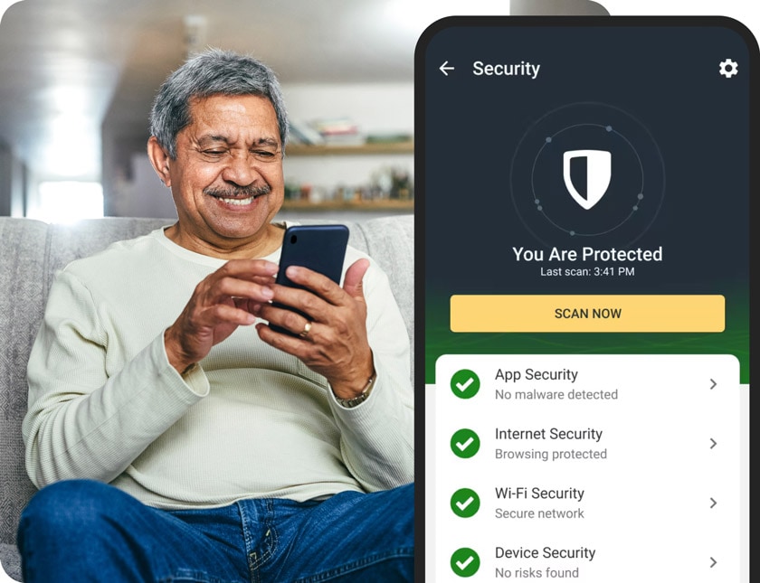 A man holding his smartphone with a screenshot of the virus scan feature in the Norton mobile security app.