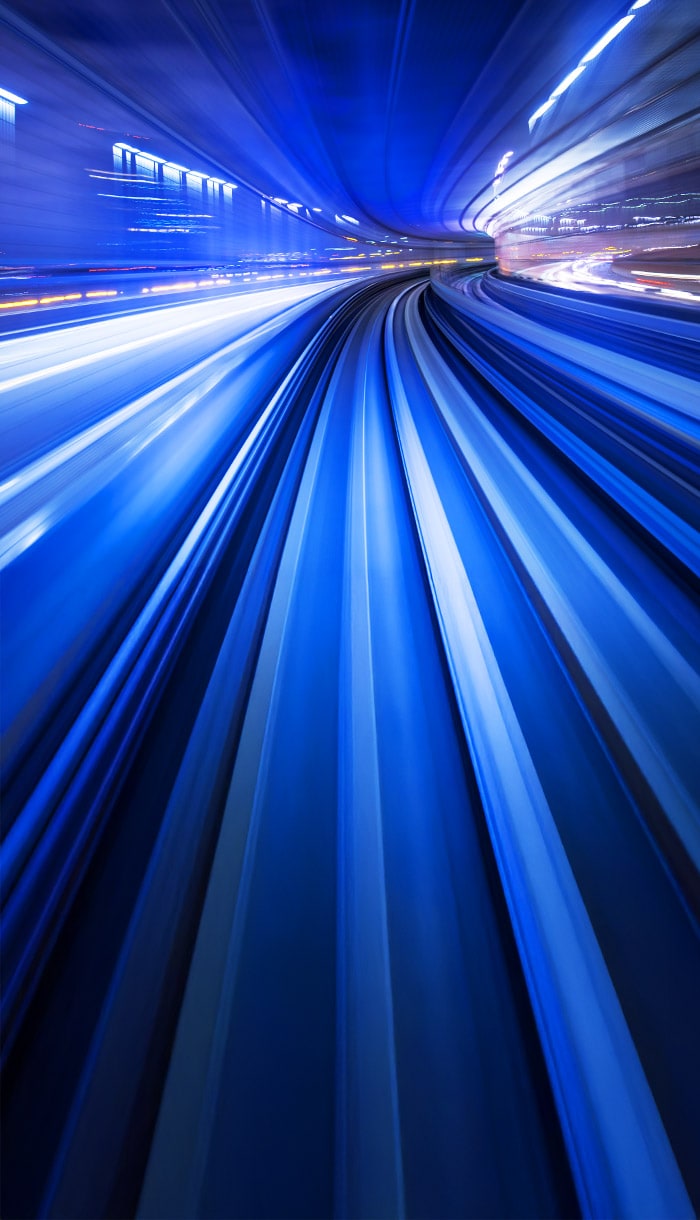 Dynamic light streaks in a tunnel, symbolizing the secure data transfer facilitated by a VPN.