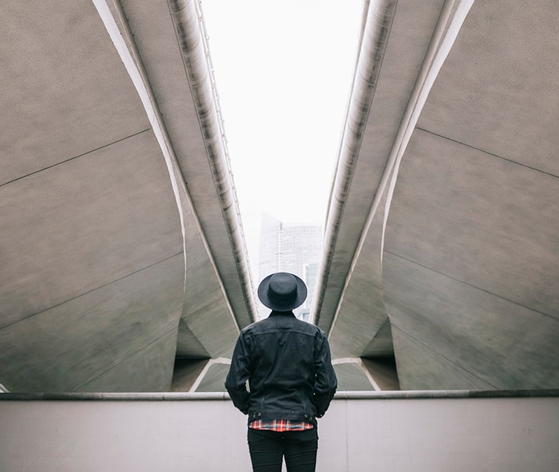A person in the middle of a bridge underpass, representing man-in-the-middle attacks.