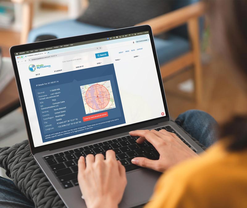 A woman looks up her IP address on her laptop using whatismyipaddress.com.
