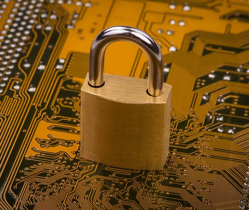 A padlock sits on a motherboard, which represents strong data security.