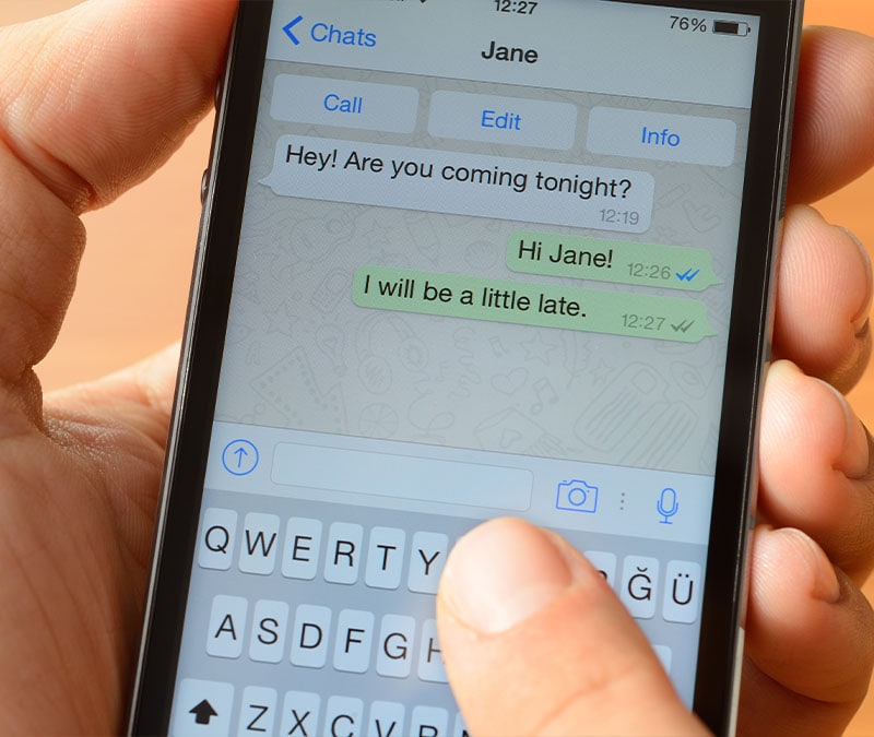 Two people confirm plans for the night via WhatsApp.