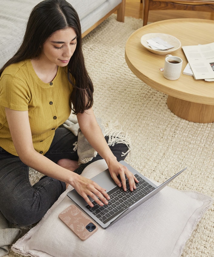 A woman using her laptop to research ways to improve her computer's performance.