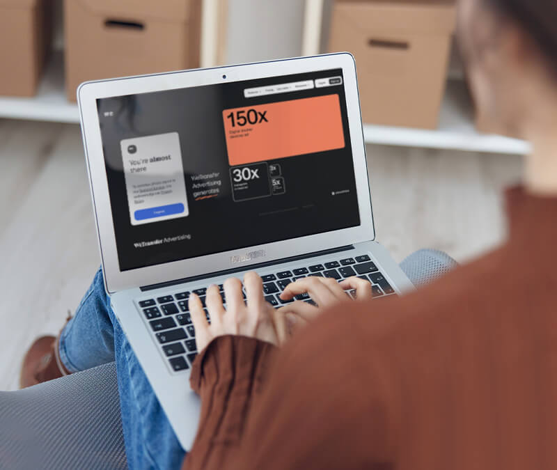 A person views a WeTransfer email on her laptop.