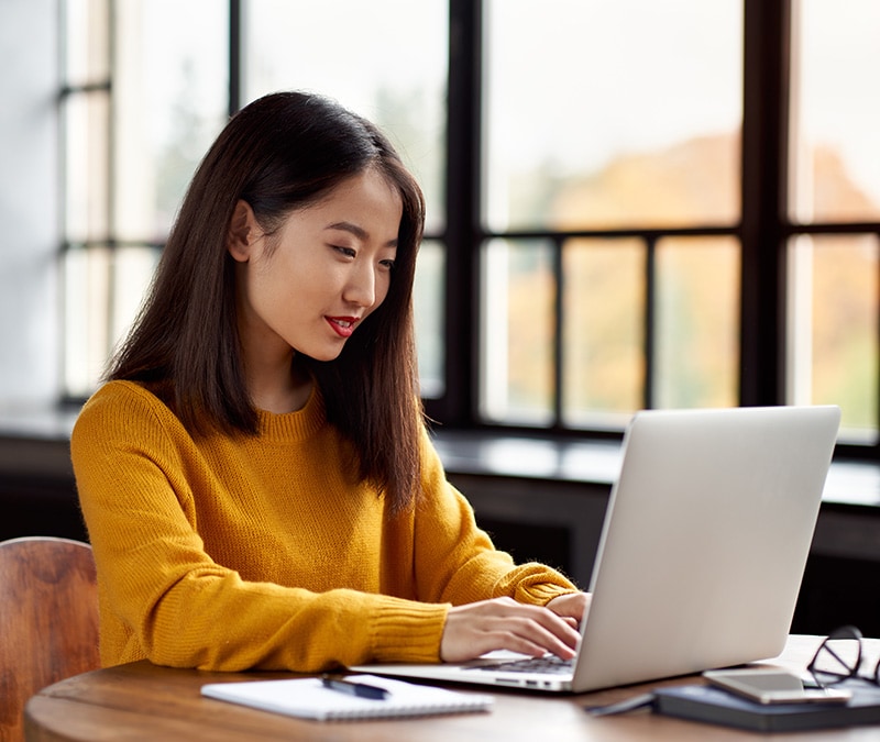 A woman learns how to send an anonymous email from her laptop.