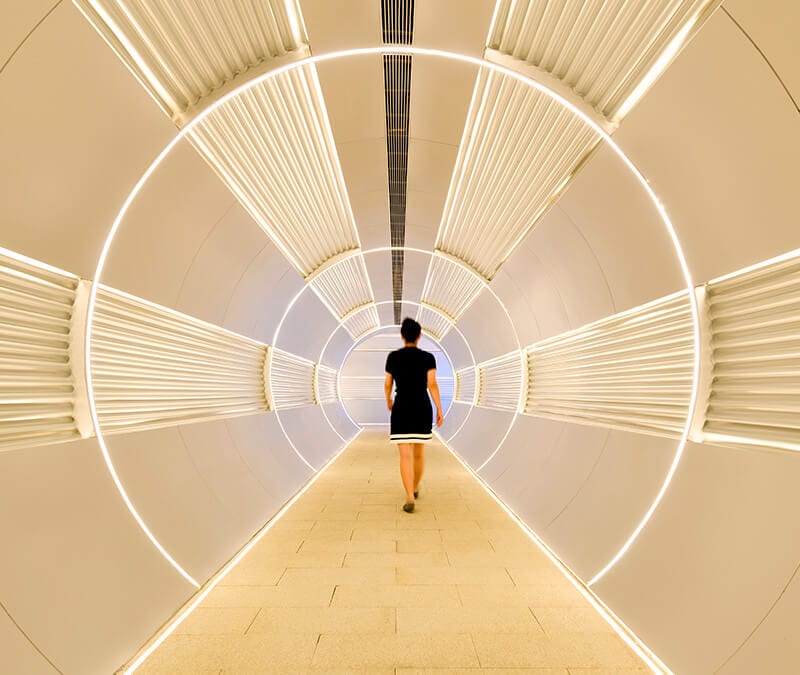 A woman walks in a tunnel to represent split tunneling.