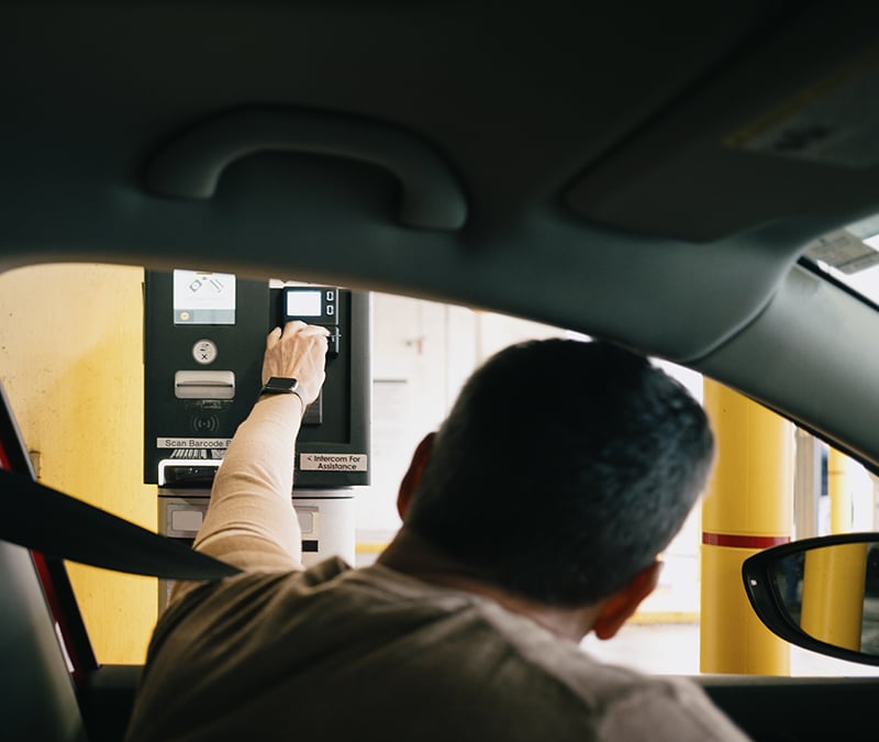 A person paying a toll at a toll road