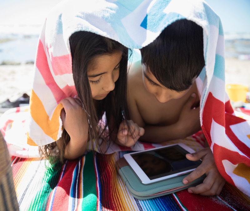 Kids using a VPN to securely connect to the internet while on vacation.