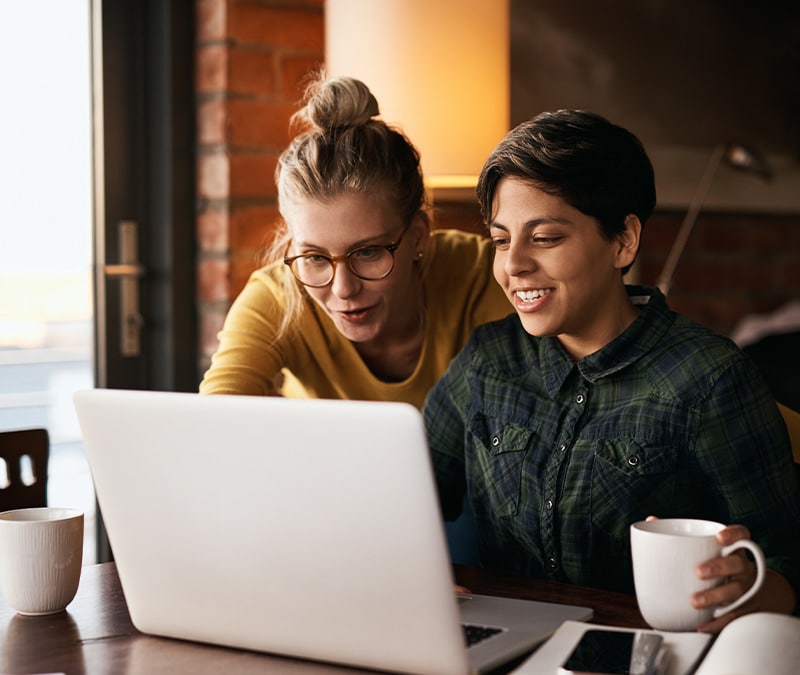 Two people with content expressions browsing the internet