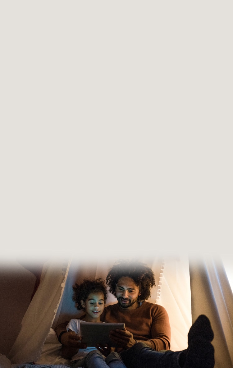 Father and daughter using tablet together