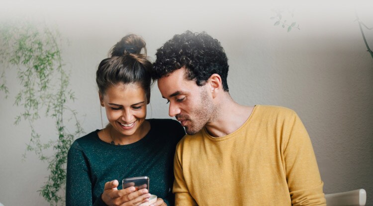 Norton Privacy - Couple looking at mobile phone