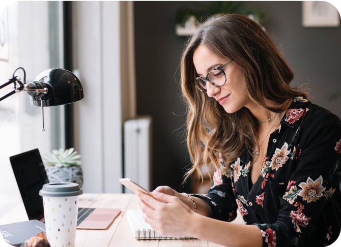 Woman in her office checking her phone
