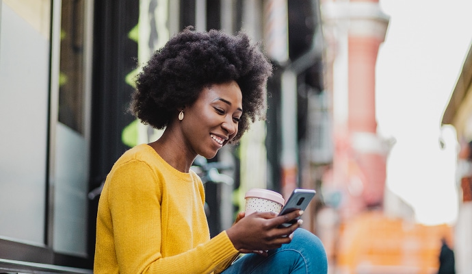 Girl holding phone and smiling