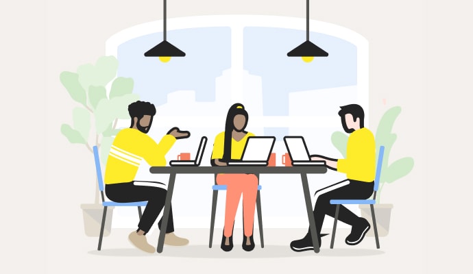 People with laptops sitting around a table