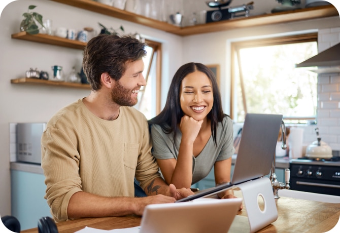 Young man using aptop in the kitchen.